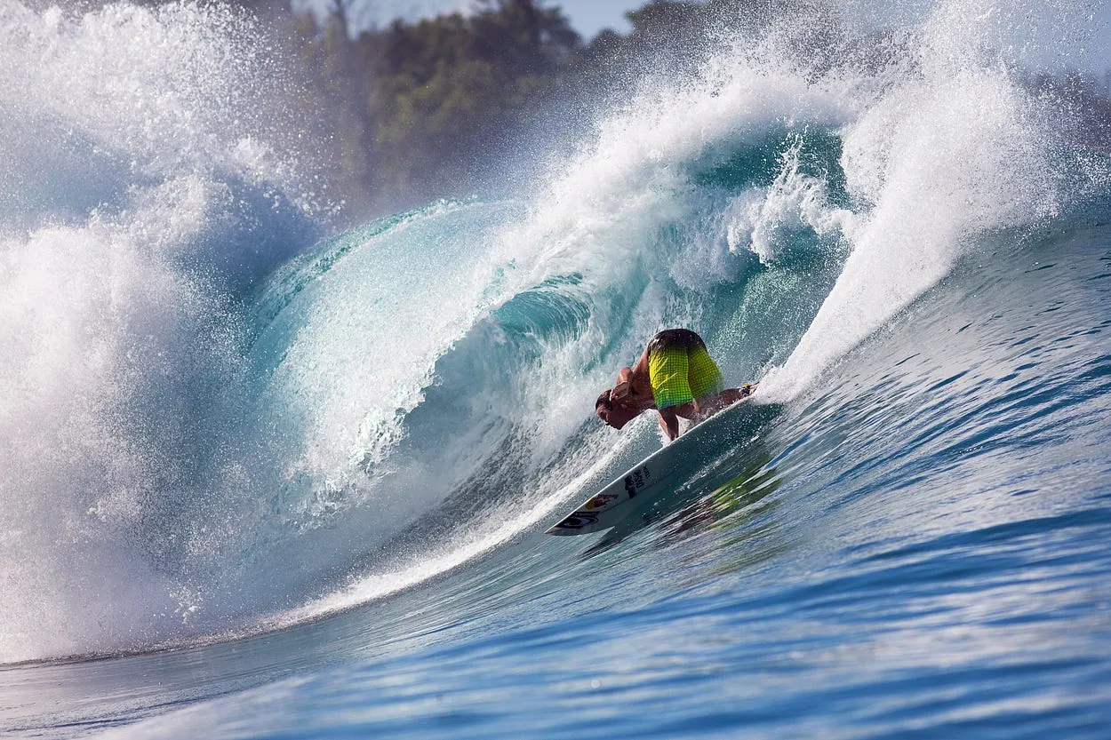 Surfer riding a wave, courtesy of Red Bull Media House