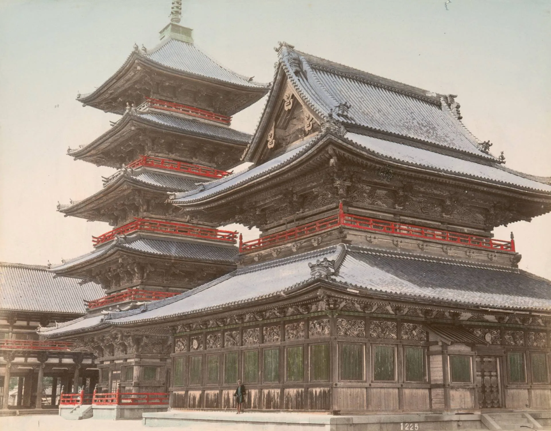 Hand-tinted antique photograph of an ornate wooden Japanese Buddhist temple hall with a five-story pagoda and red railings