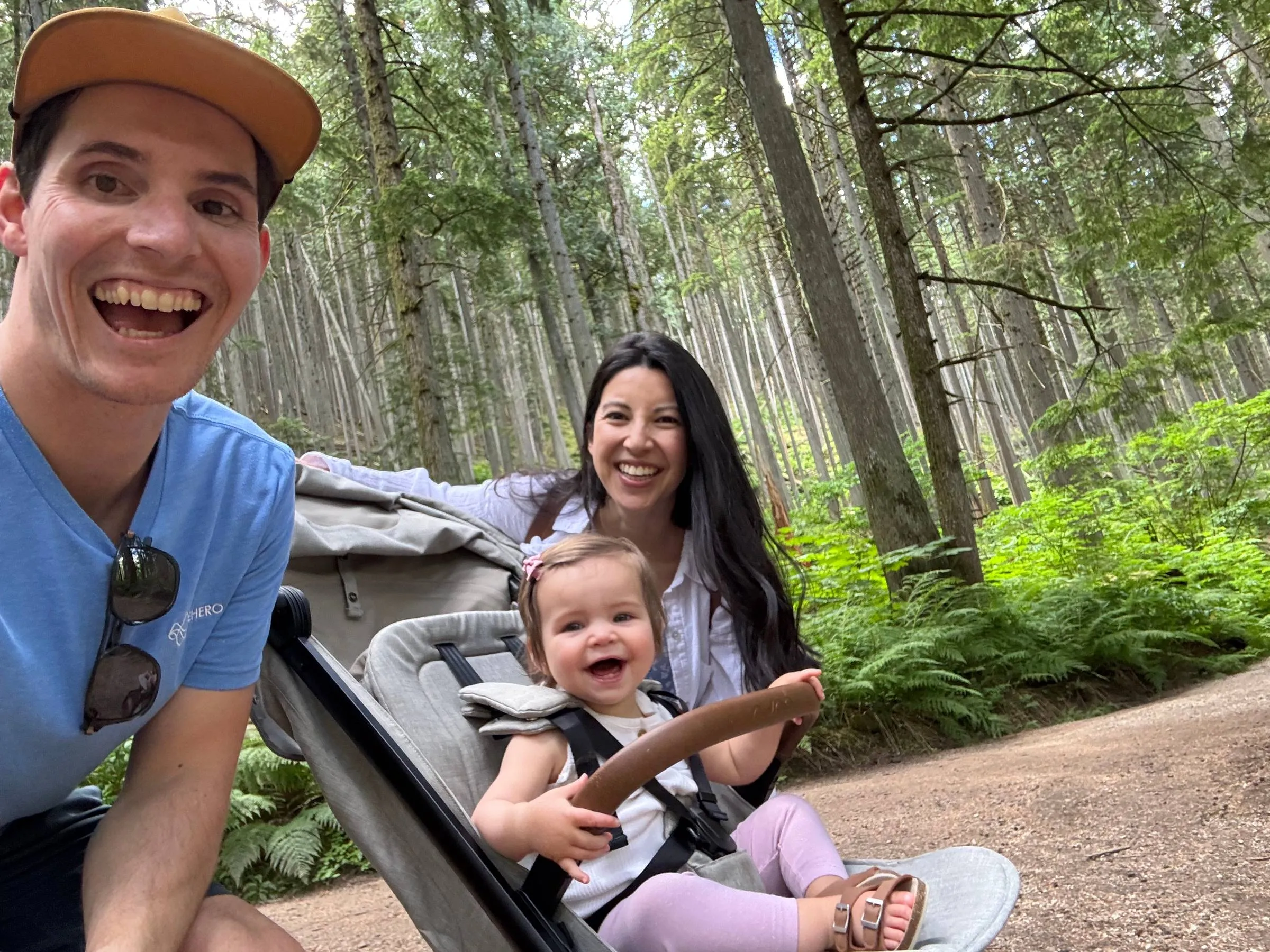 Selfie of the author, his wife, and toddler in a stroller on a forest trail