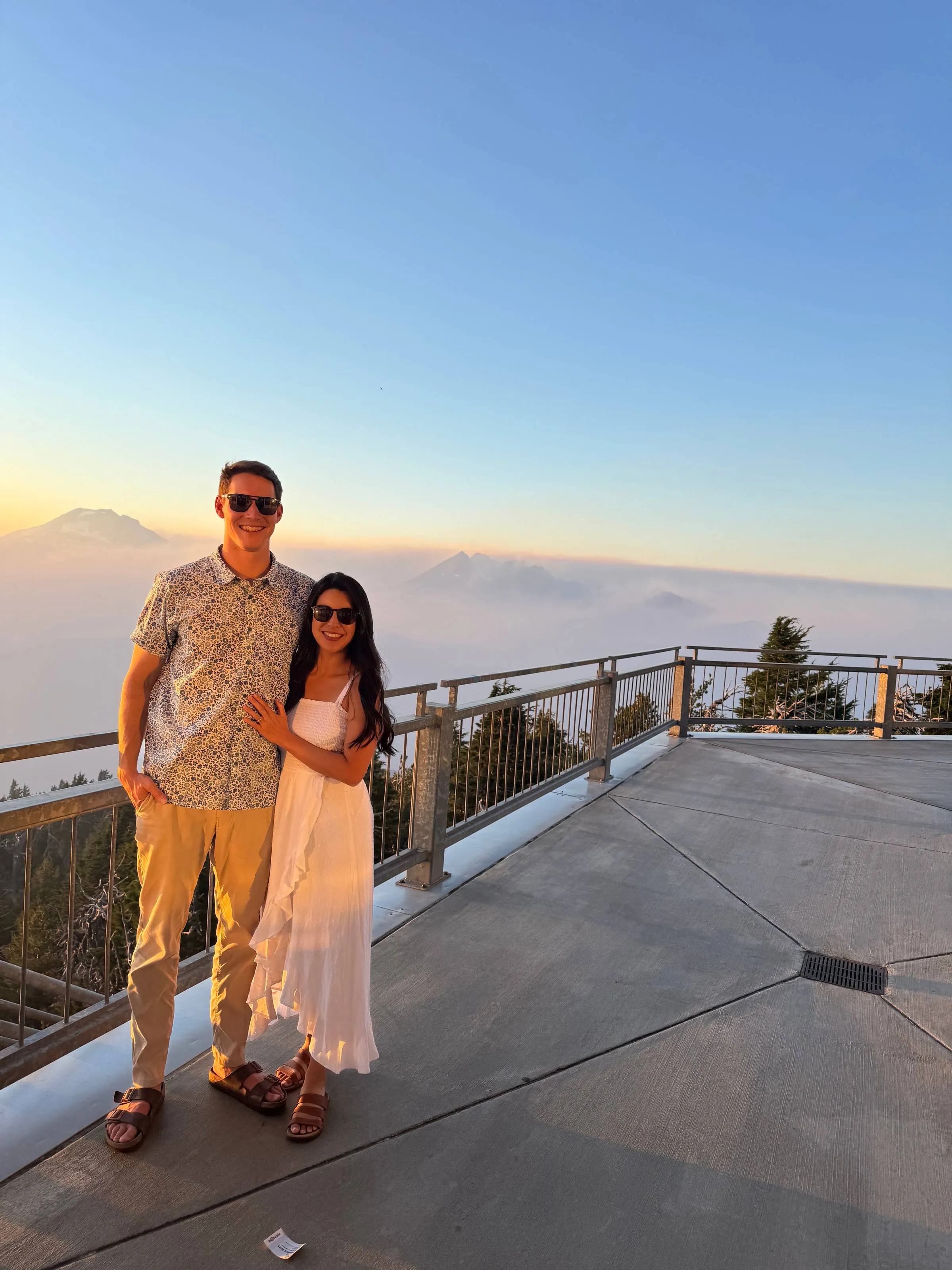 Ben and his wife posing at a mountaintop viewpoint at sunset on Mt. Bachelor
