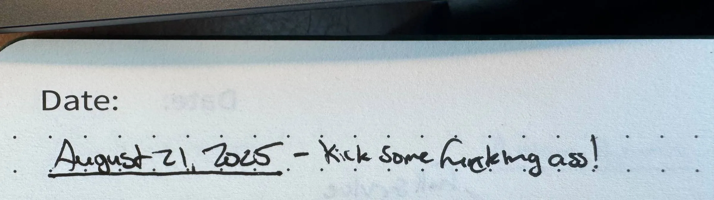 Handwritten note in a dated notebook reading “August 21, 2025 - Kick some f*cking ass!”
