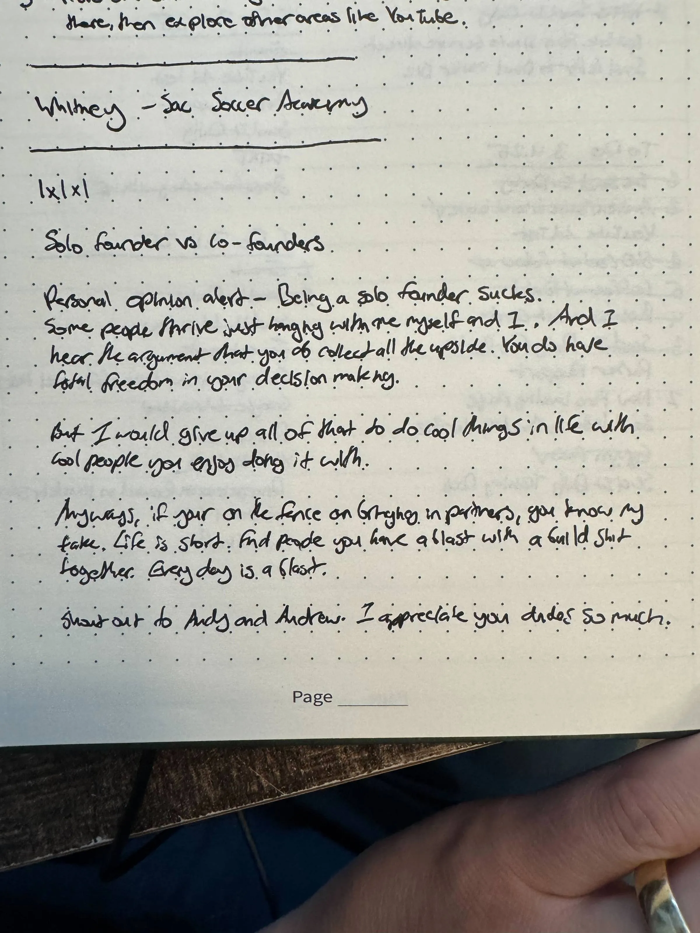 Handwritten journal page on dotted paper with notes on solo founder versus co-founders