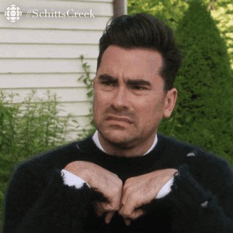 David Rose from Schitt’s Creek making a disapproving, thumbs-down gesture